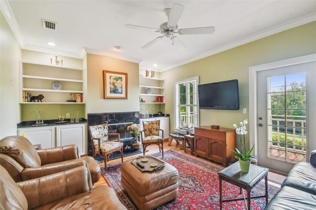 The bright Living Room with a window and a door to the private porch with the partial Bay view for entertaining!