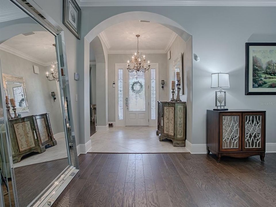 THE ARCHWAYS LEAD YOU TO THE "STUDY" ON THE LEFT AND THE MAIN LIVING AREA WITH WOOD LOOK PORCELAIN TILE FLOORING.