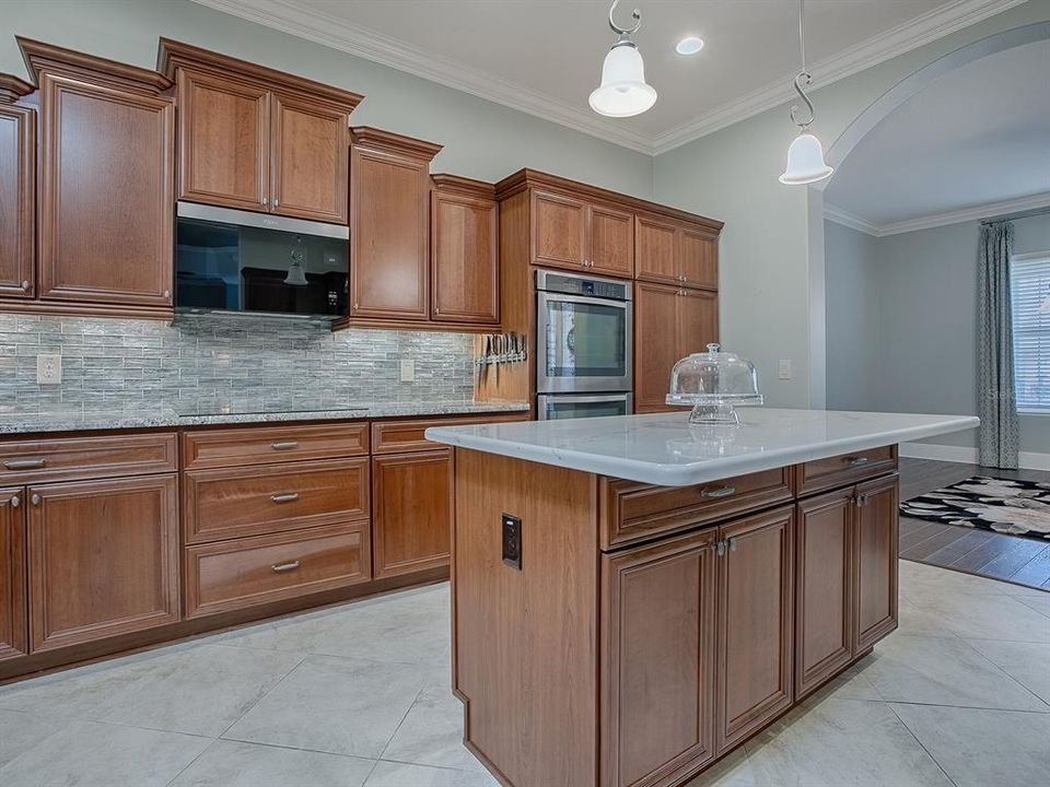 GLASS TILE BACKSPLASH - SMOOTH TOP ELECTRIC COOKTOP - UNDERCABINET LIGHTING - PENDANT LIGHTING OVER THE ISLAND.