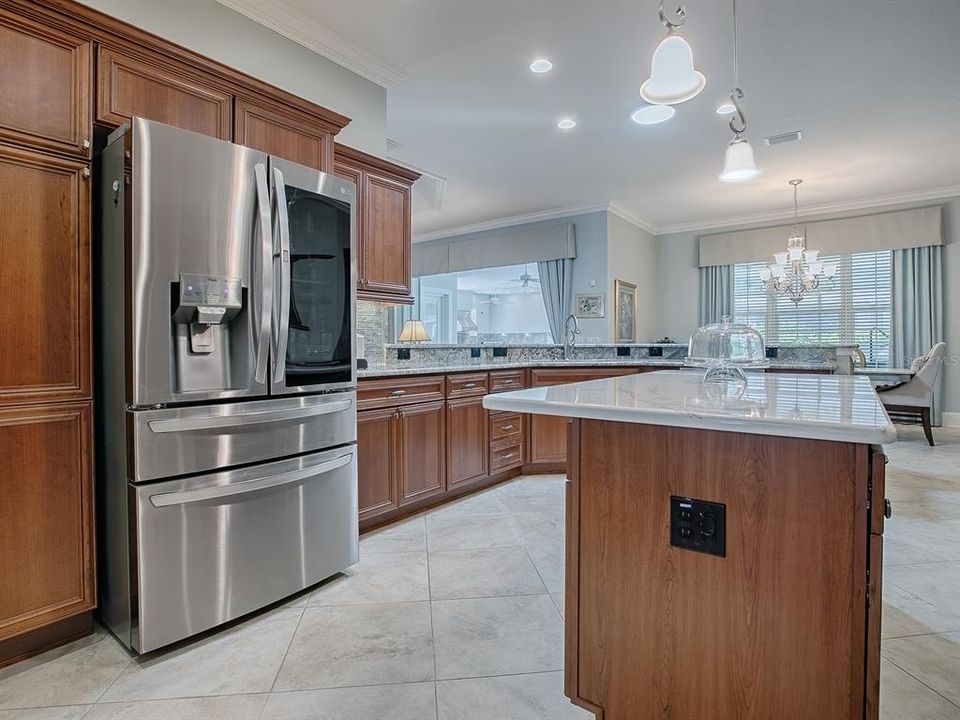 TOUCH SCREEN STAINLESS BOTTOM FREEZER REFRIGERATOR WITH ANOTHER CLOSET PANTRY TO THE LEFT.