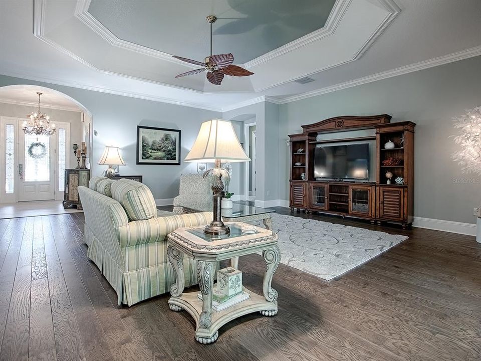 LOVELY LIVING ROOM WITH TRAY CEILING WITH CROWN MOLDING TRIM AS WELL AS CROWN THROUGHOUT THE ENTIRE HOME.