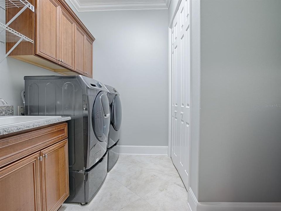 BUILT-IN SINK, EXTRA CABINETS, FRONT LOAD WASHER AND DRYER ON PEDESTALS 9THEY DO CONVEY WITH THE HOME, AND A LARGE STORAGE CLOSET