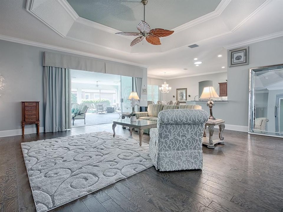 LIVING ROOM OPENS WITH STACKBACK SLIDING GLASS DOORS OUT TO THE OVERSIZED LANAI.