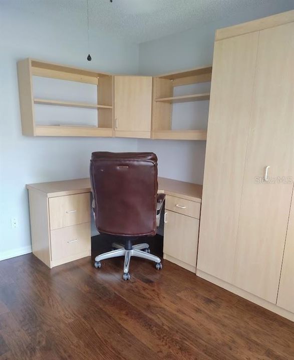 2nd bedroom with a murphy bed and built in desk