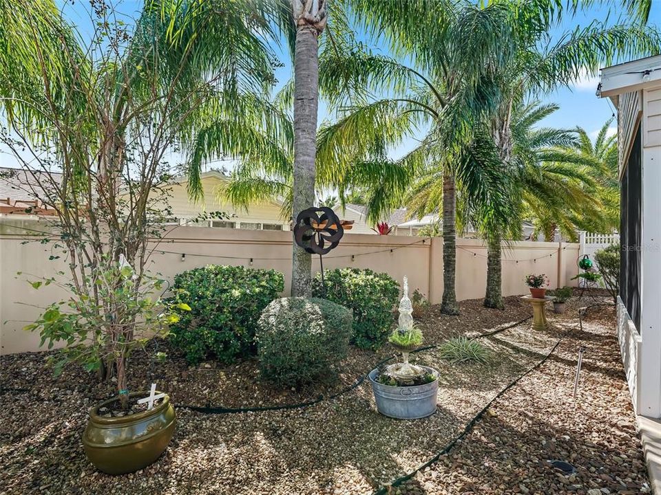 Backyard showing pebbled walkways and no grass to cut!