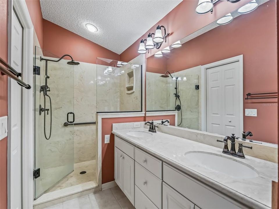 Main bath and walk-in closet. Note the cultured marble counters and double sinks.