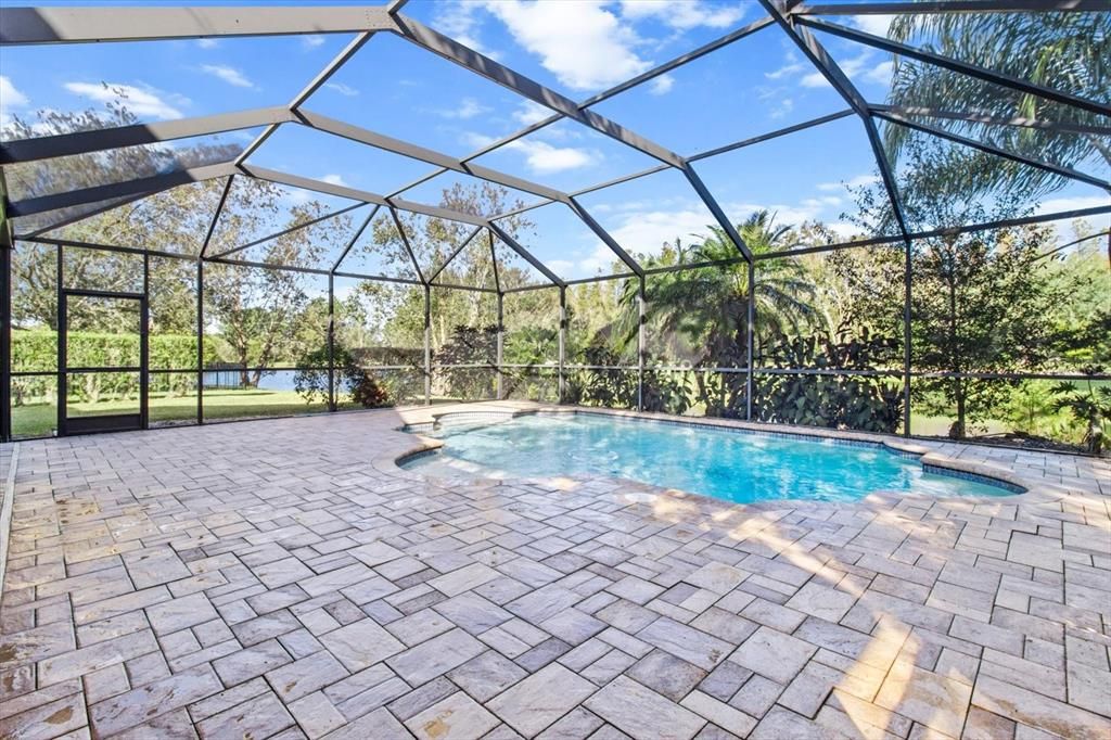 Brick patio and Custom 6' Heated Pool with In Pool Seating and Fountain Water Feature