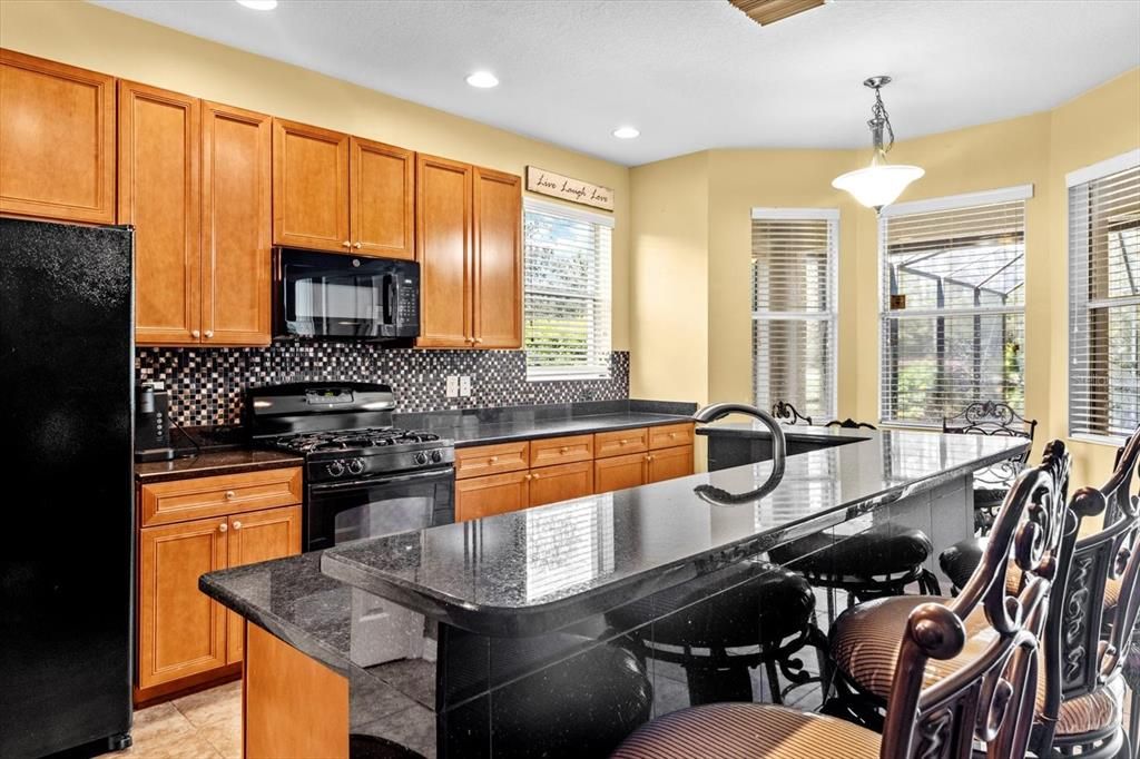 Kitchen and High Top Breakfast Bar with Marble Accents