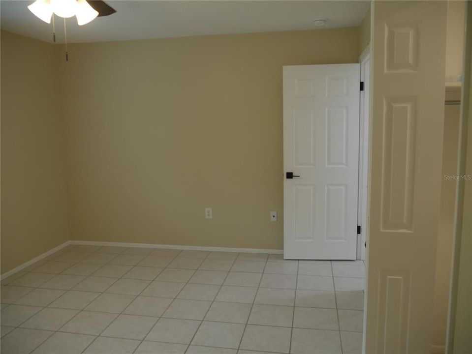 Primary bedroom looking from 1/2 bath doorway.  Large walk-in closet is to the right.