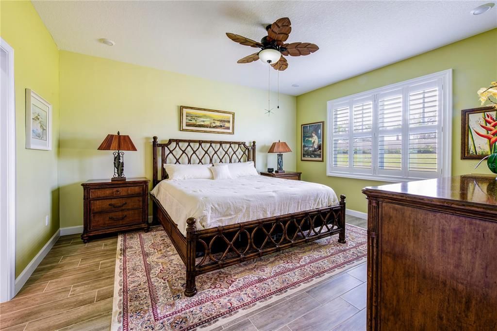 Primary Bedroom-Split floor plan, Upgraded with Plantation Shutters on every window of home, upgraded with ceiling fan