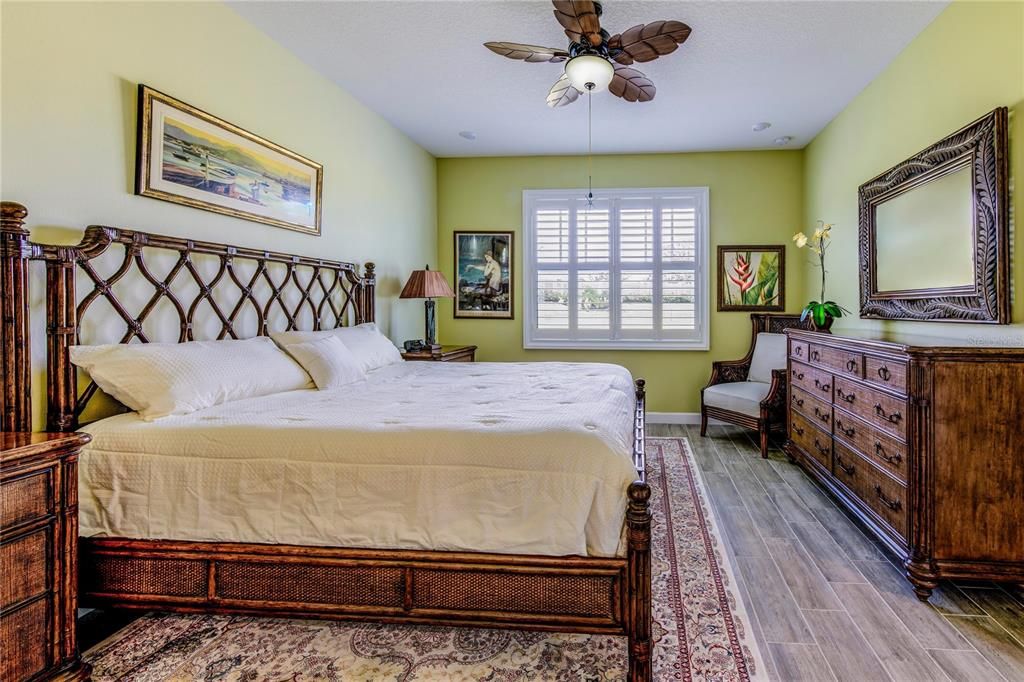 Primary Bedroom-Split floor plan Upgraded with Plantation Shutters on every window of home, upgraded with ceiling fan