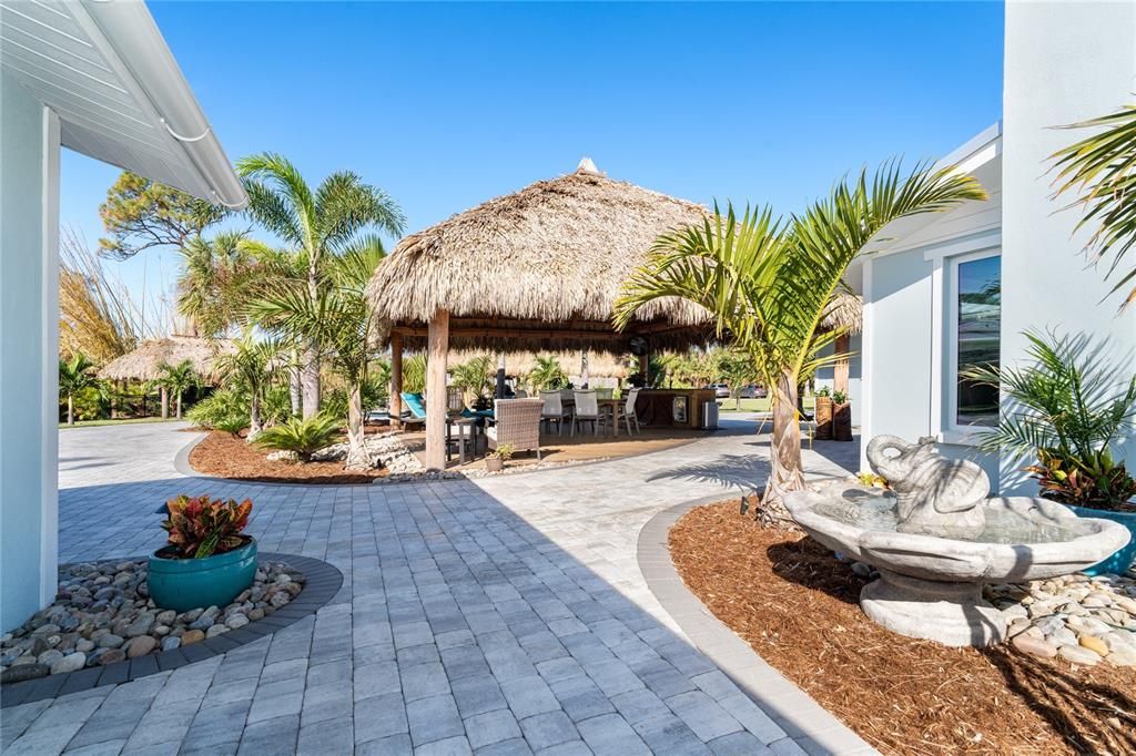 Paver walkway from Garage and Family Room to outside entertaining under the Tiki Hut