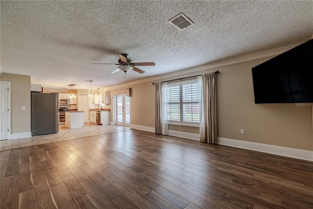 Living Room view to Kitchen and French Doors to Backyard