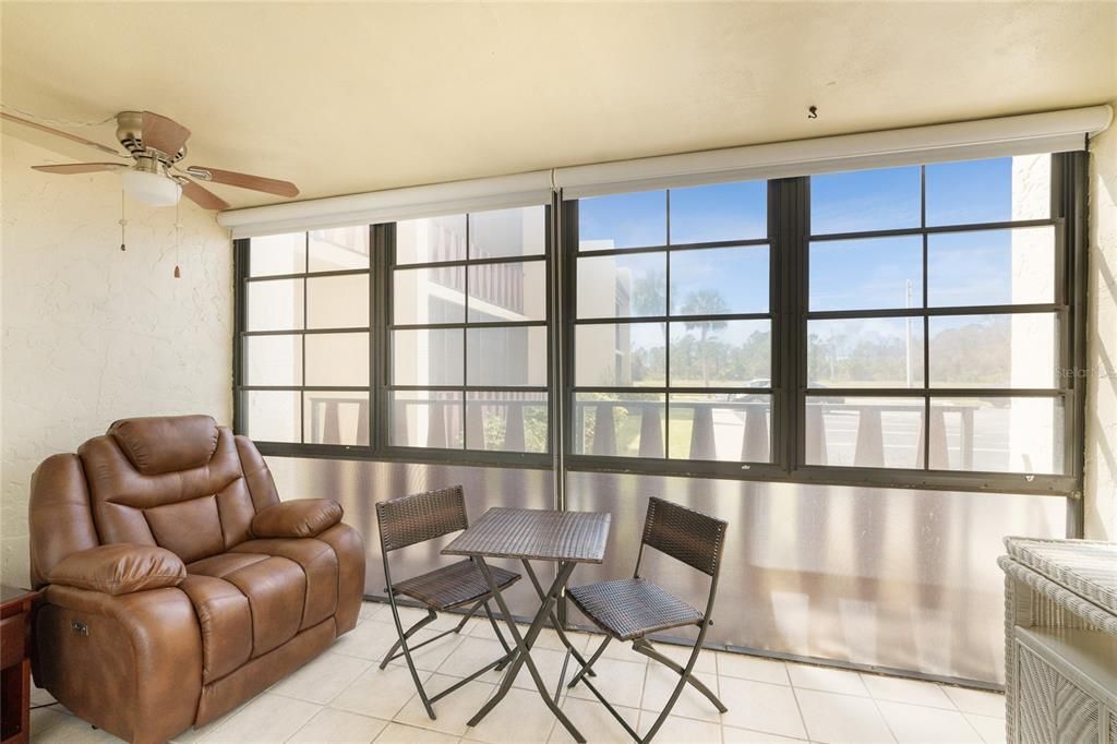 Enclosed lanai with lots of natural light and a ceiling fan.