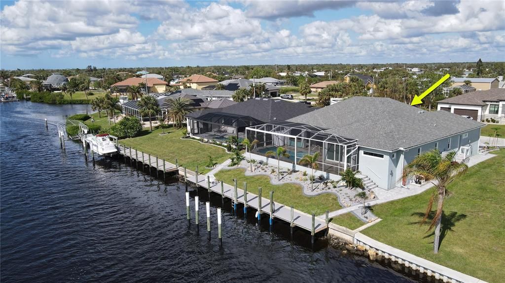 Rear aerial view of home and waterfront