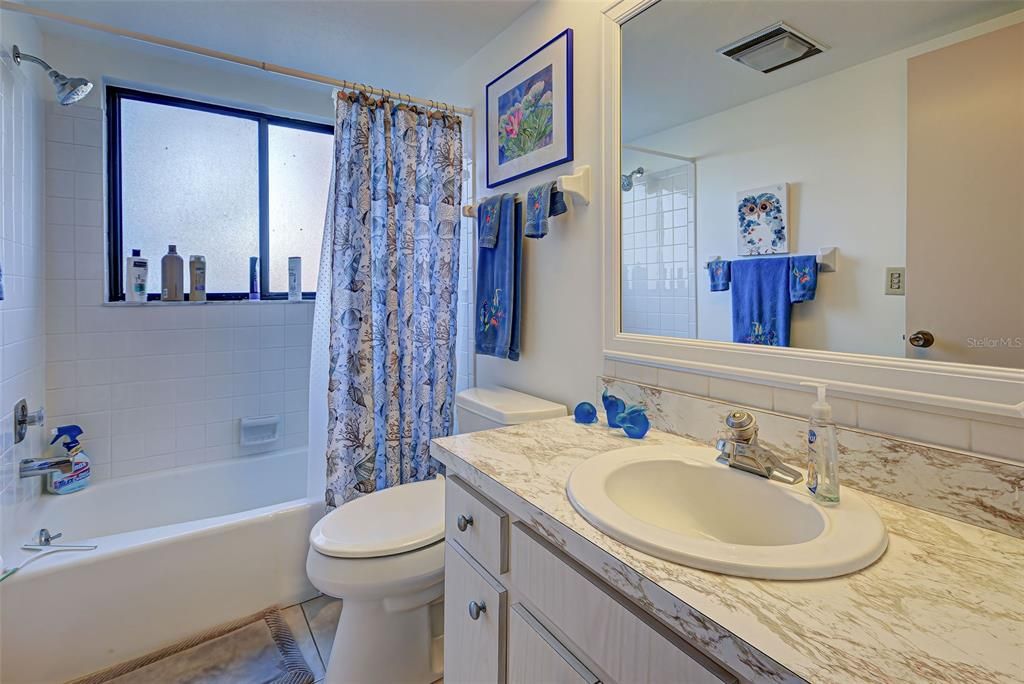 GUEST BATHROOM WITH TUB/ SHOWER COMBINATION.