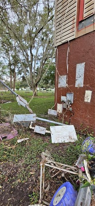 Exterior rear view showing storm damage to electrical panel