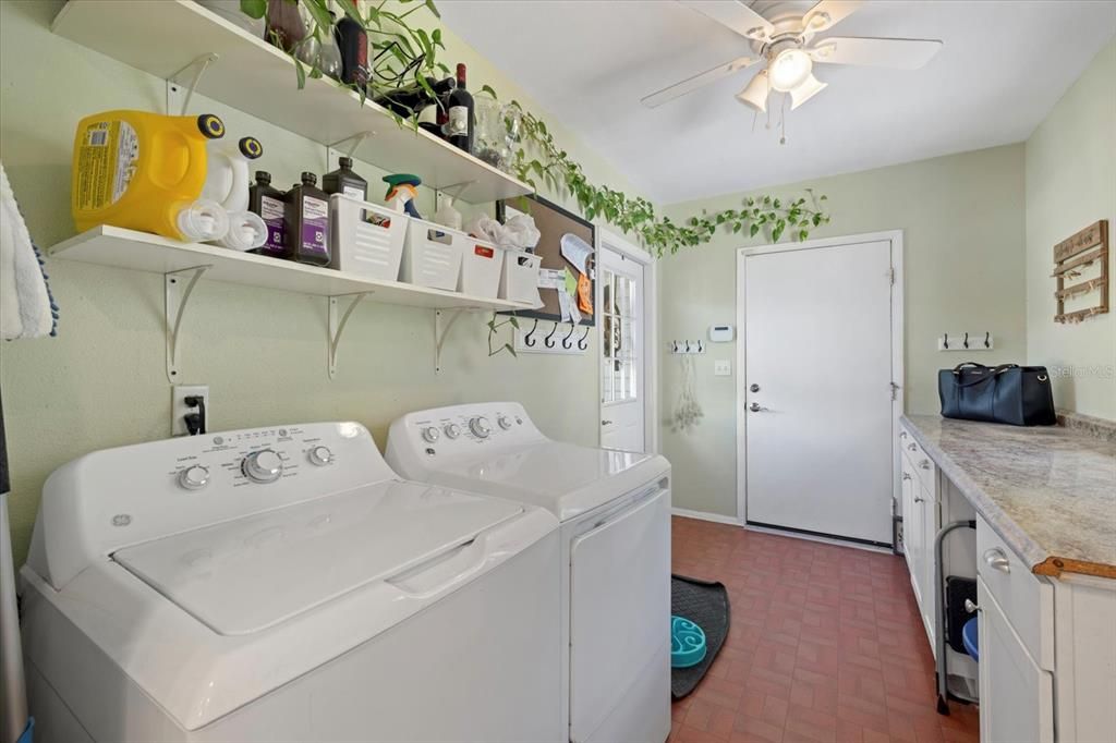 Laundry room with Garage Door in distance and side door access door to the left