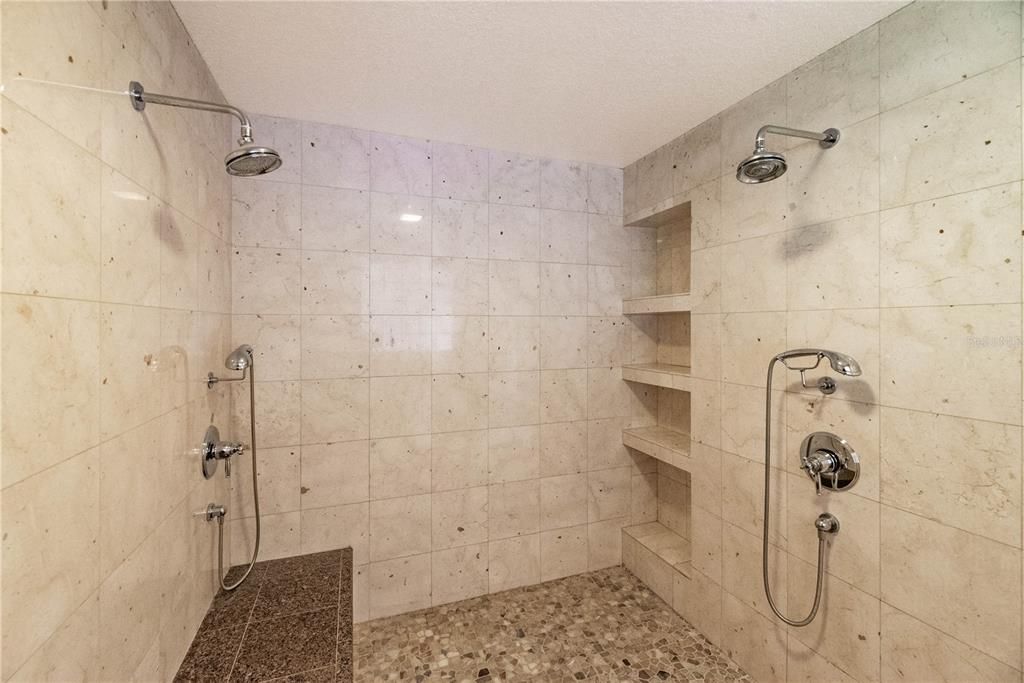 Primary Bathroom - multiple shower heads, build-in shelfs, shower bench