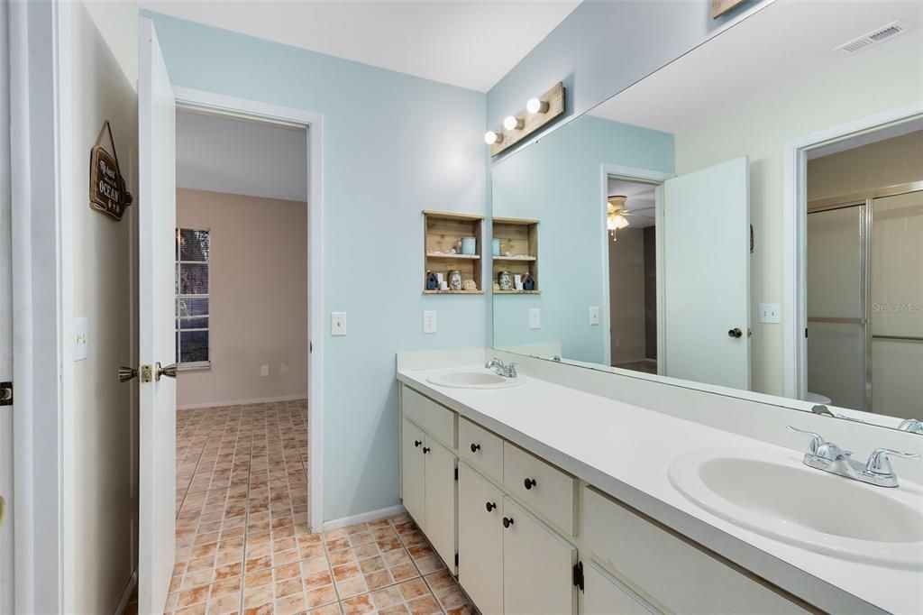 Secondary bath includes dual sinks and a walk-in shower.