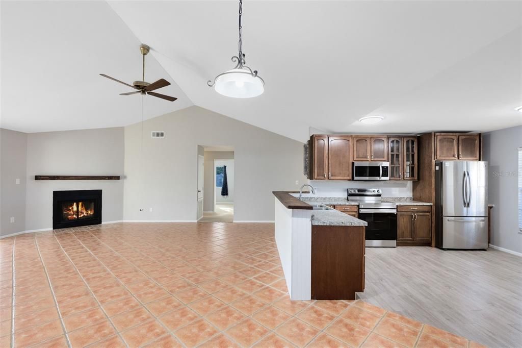 The eat-in kitchen is a delight, equipped with a breakfast bar for additional seating, stainless steel appliances, and a spacious walk-in pantry.