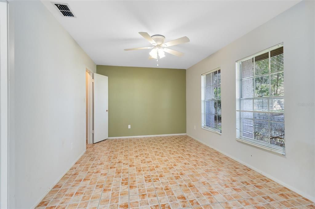 A large secondary bedroom is located just off the front foyer.