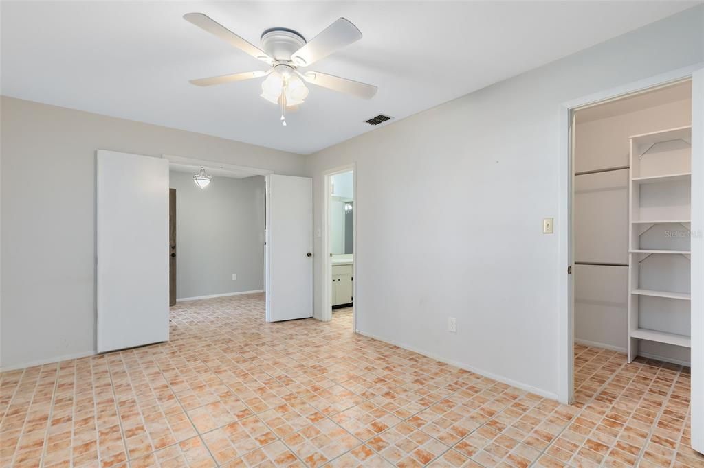 This bedroom has a walk-in closet and a ensuite bath that is shared with the adjoining hallway to the additional bedrooms.