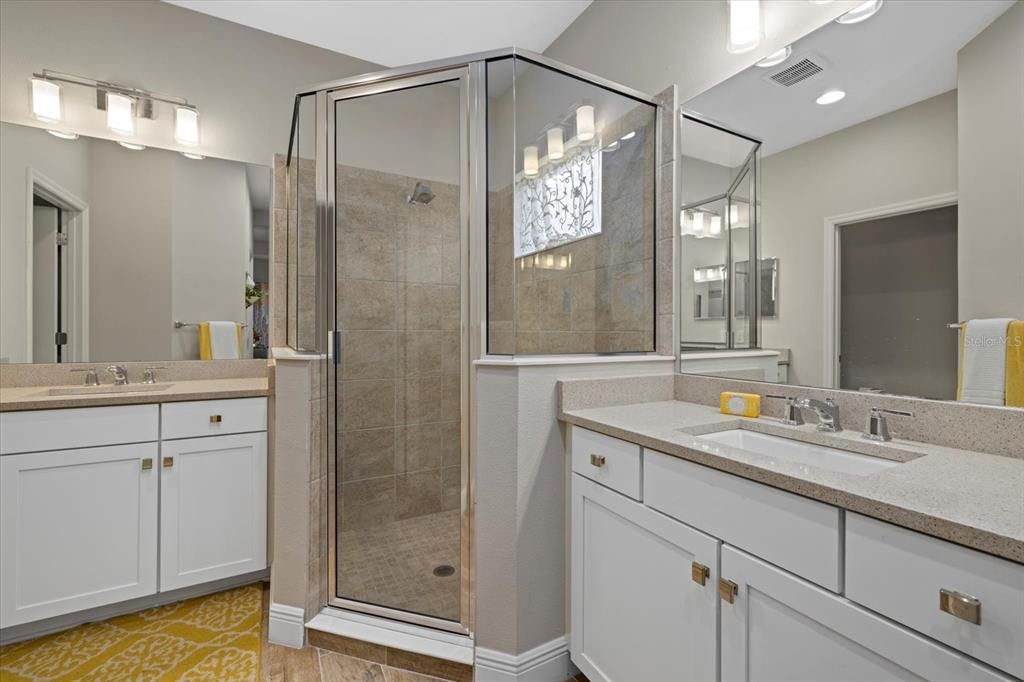 Primary bathroom with a walk-in shower & dual sinks