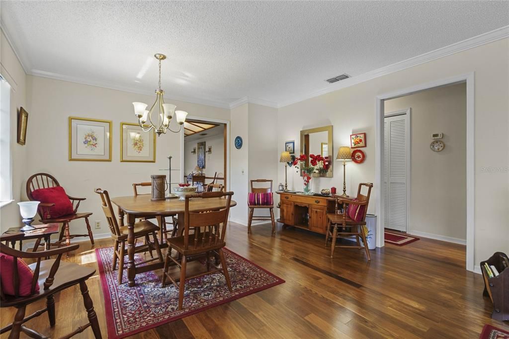 Formal Dining Room is enhanced with Crown Molding & Updated Chandelier