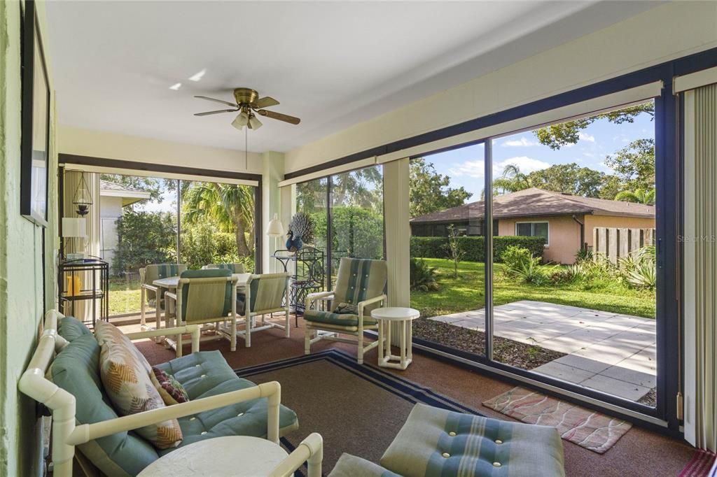 Florida Room features 5 Glass Sliding Doors provide seamless access to the backyard patio, allowing you to enjoy the outdoor living space.