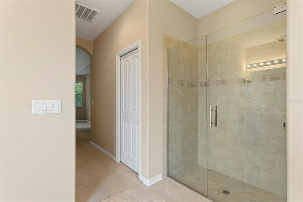 New frameless glass shower door in the primary bath