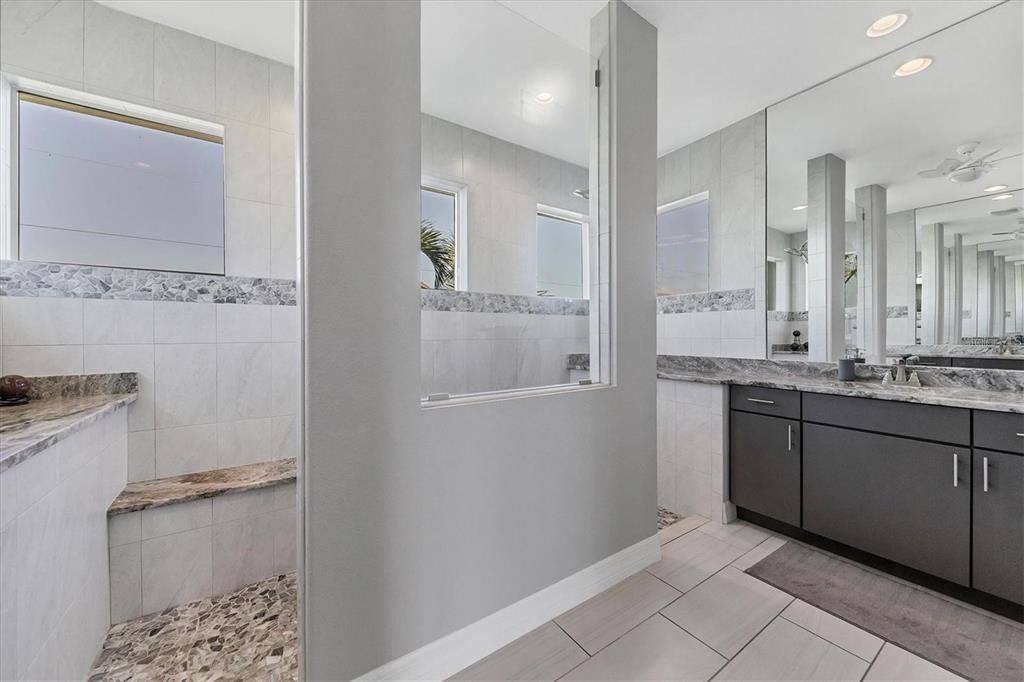 Modern ensuite featuring a walkthrough shower with a refreshing rain head