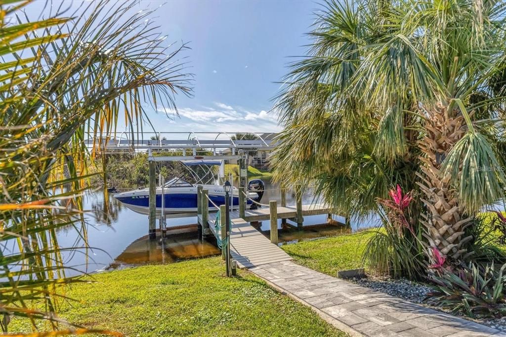 Direct access to the water via a durable composite dock with a 10,000 lb lift, canopy, water, and electric hookups—ideal for boating enthusiasts.