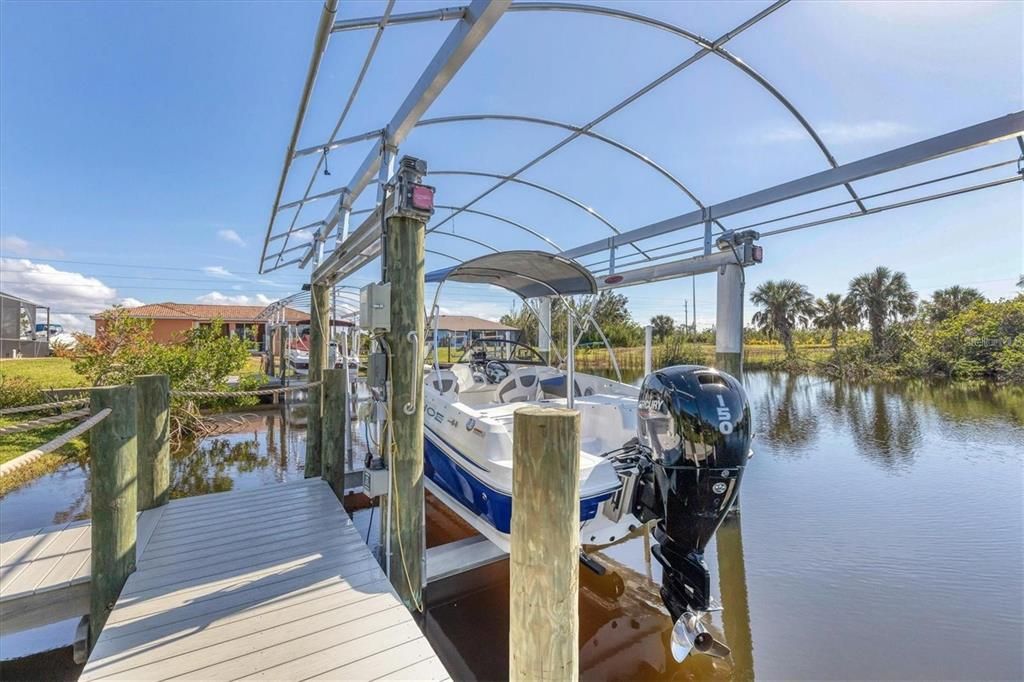 Direct access to the water via a durable composite dock with a 10,000 lb lift, canopy, water, and electric hookups—ideal for boating enthusiasts.