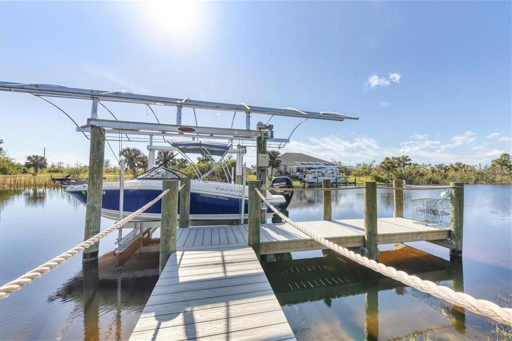 Direct access to the water via a durable composite dock with a 10,000 lb lift, canopy, water, and electric hookups—ideal for boating enthusiasts.