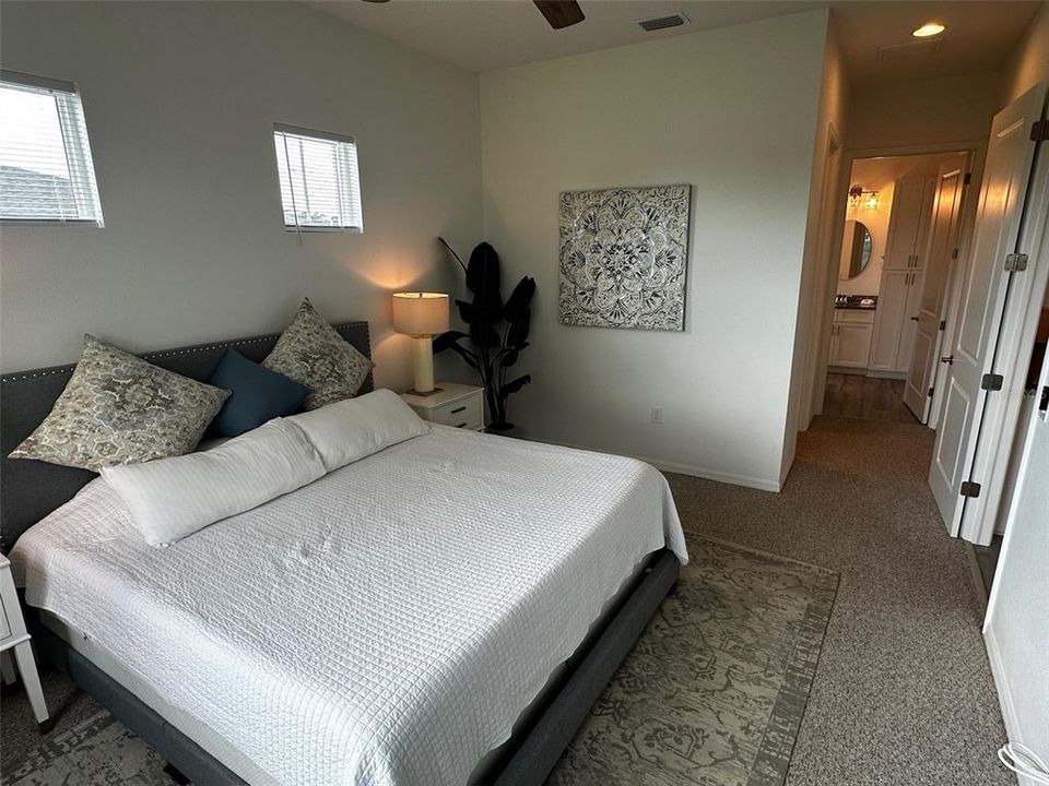 Primary king-size bedroom with walk-in closet, En-suite bathroom with dual vanity and walk-in shower.