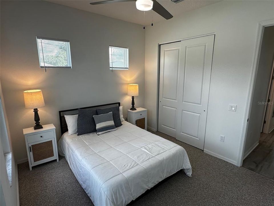 Bedroom 3 with queen-size bed and four windows to allow lots of natural light.