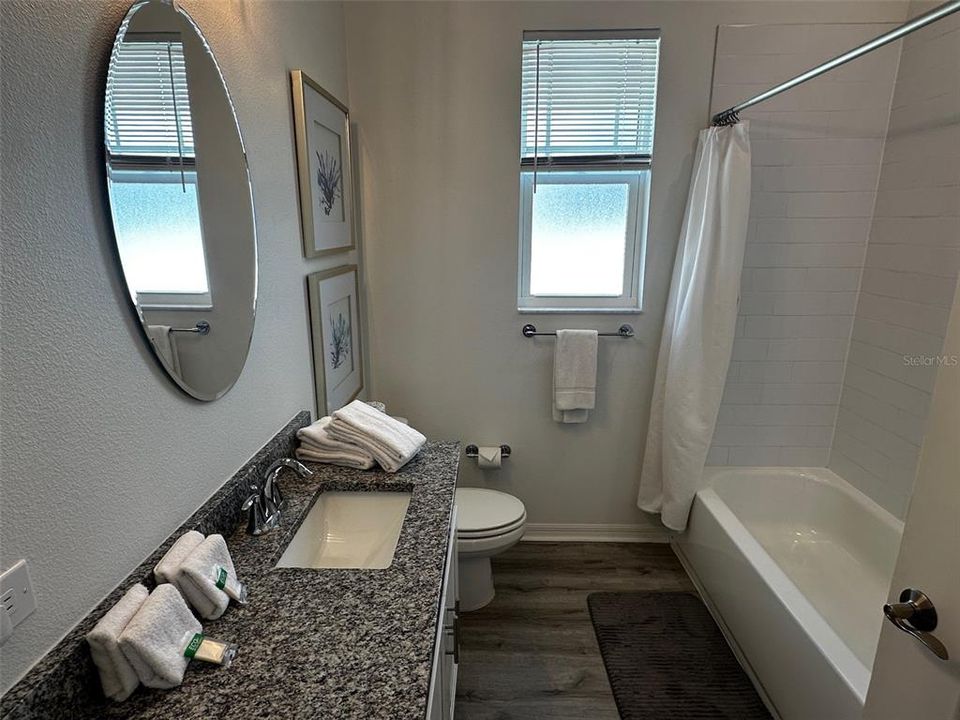 Bathroom 2 with tub and shower located between bedrooms two and three.