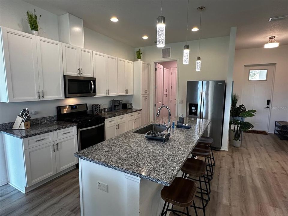 Kitchen Area with Modern design with vaulted ceilings and open floorplan. Gourmet Chefs' kitchen with new appliances and gas stove.