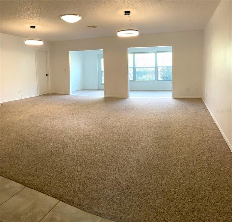 From entryway into living room, with beautiful view into the enclosed lanai.