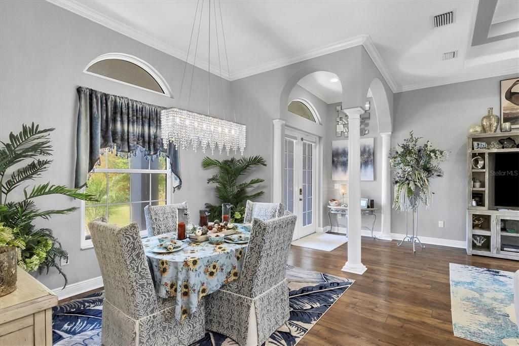 Dining Room & entry accented with eyebrow windows and decorative columns and arches