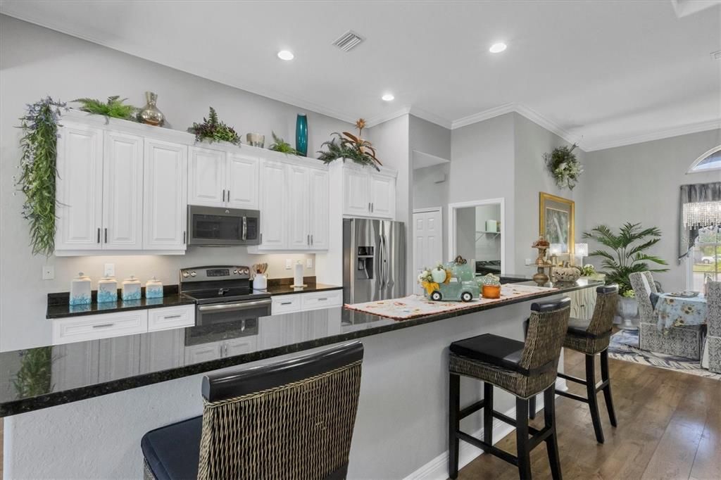 Kitchen features soft close cabinetry, stone counters & stainless appliances