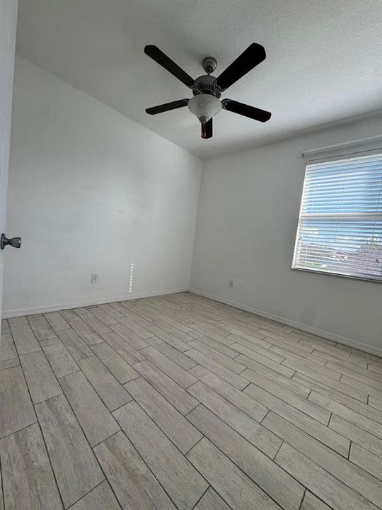 Bedroom 1: hard floors, nice ceiling fan, with window