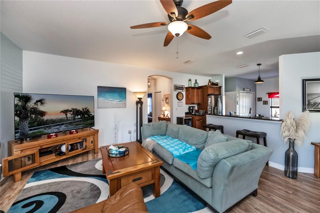 A warm and friendly feeling in the pleasant living room which also opens into the kitchen with a breakfast bar in between.