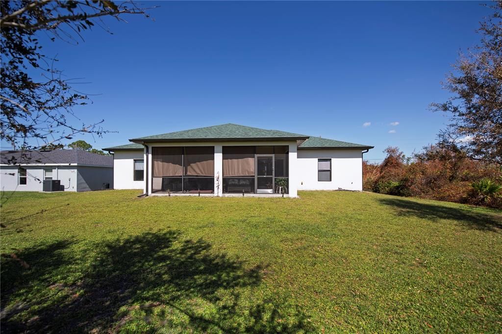 Beautiful view of rear of home showing large lanai!  Plentry of room for a pool shoulld you decide you want one in the future.