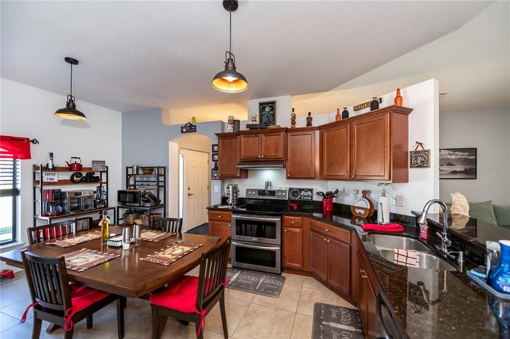 The Heart of the Home!!! This beautiful kitchen has an abundance of cabintry, counters, breakfast bar and still room for the pleasant sized table for the everyday meals.