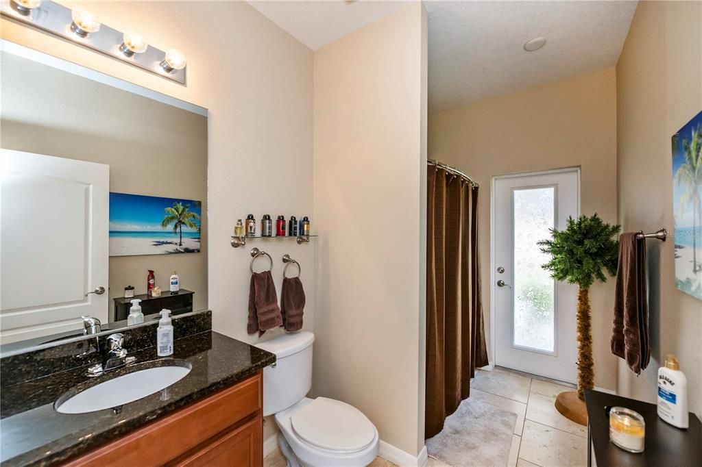 Guest bathroom with door to outside.