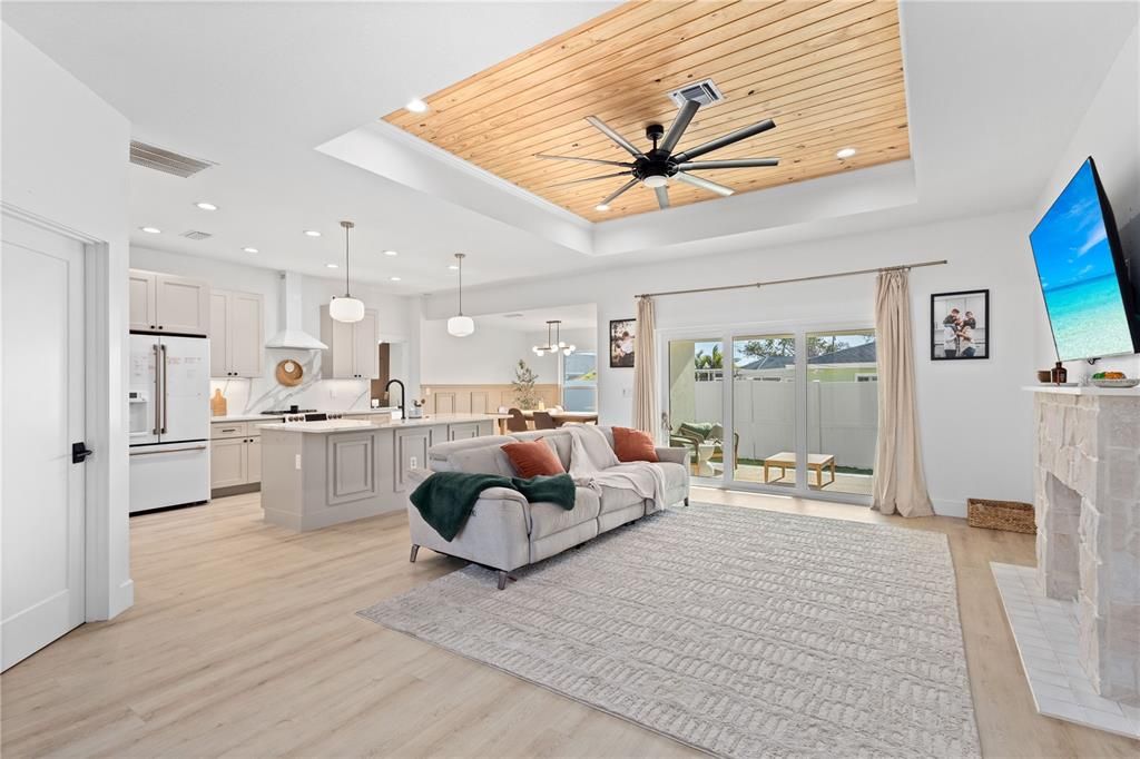 Intricate Tray Ceiling with natural shiplap.  Stone Fireplace.  Open Floor Plan