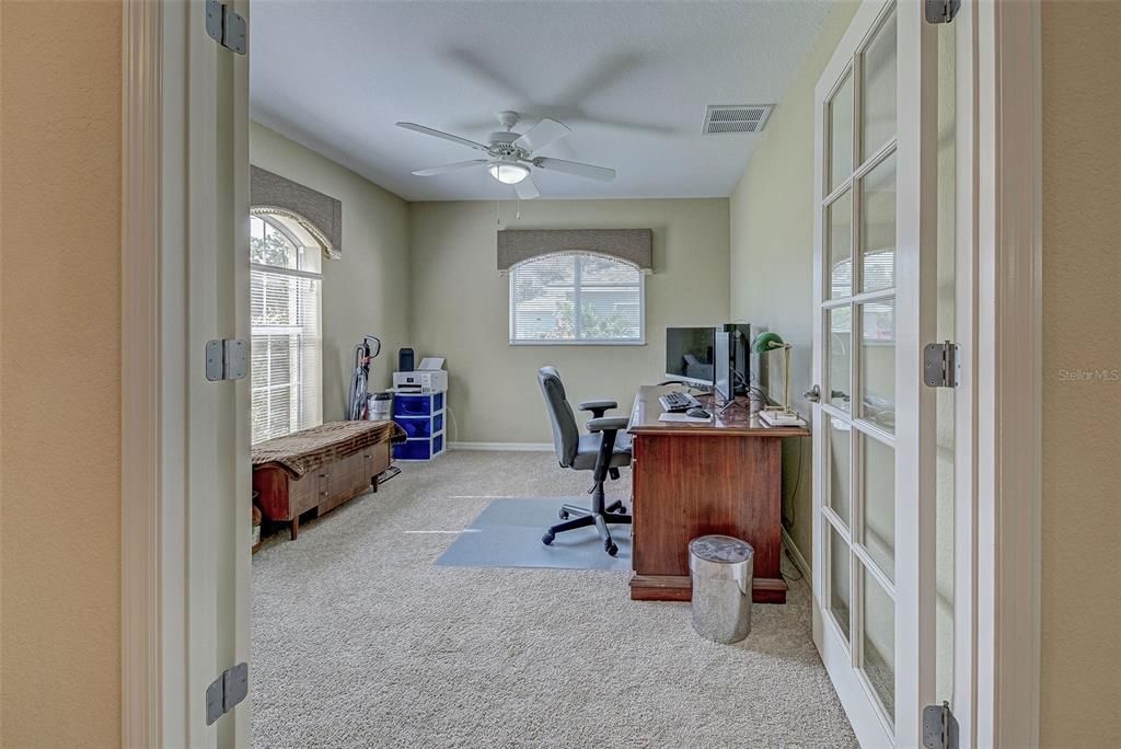 Beautiful double french doors open up to the office/den/gym/craft room.