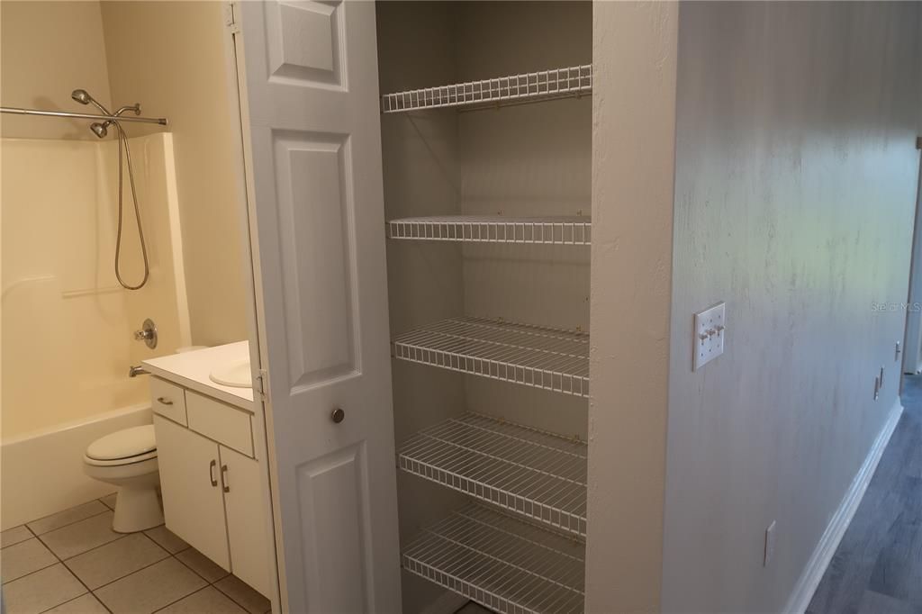 Storage closet located next to bathroom